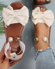 Jaxoria - Vrouwen platte sandalen met decoratieve strik en parels