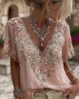 Kirelina - Vrouwelijke blouse met geborduurde bloemen en elegante V-hals